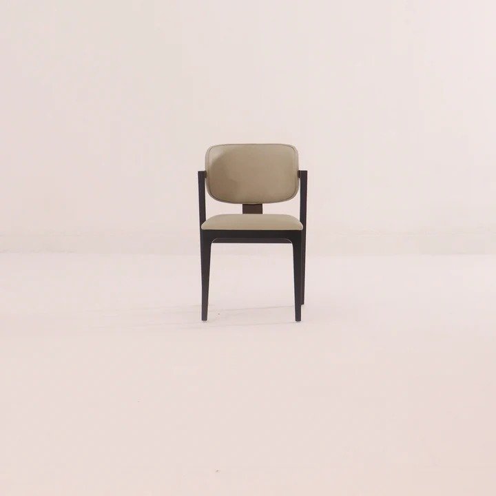 Balthazar Dining Chair handcrafted from solid wood with an upholstered backrest, cushioned fabric seat, and elegant walnut finish.