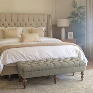 Royal Upholstered Bed with a deep button-tufted fabric headboard, matching upholstered bench, and solid wood legs in a luxurious king-size bedroom.