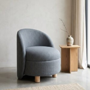 Nova Accent Chair upholstered in premium grey fabric with a curved barrel back, cushioned seat, and solid wood legs.