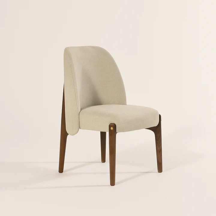 Potter Dining Chair handcrafted from solid wood with a curved upholstered backrest, cushioned fabric seat, and walnut finish.