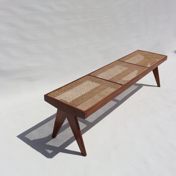 Modern solid Acacia wood bench with a handwoven natural cane seat and minimalist tapered legs.