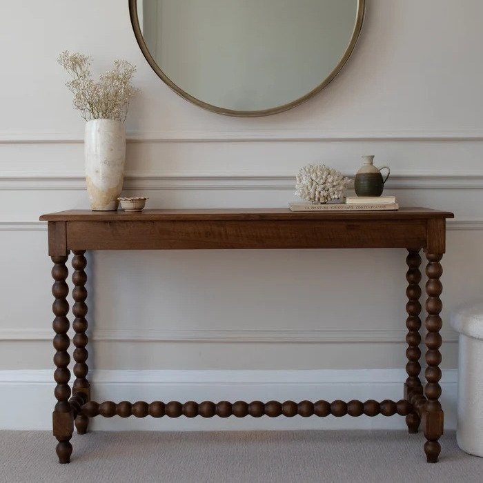 Traditional wooden console table with turned spindle legs and decorative lower stretcher