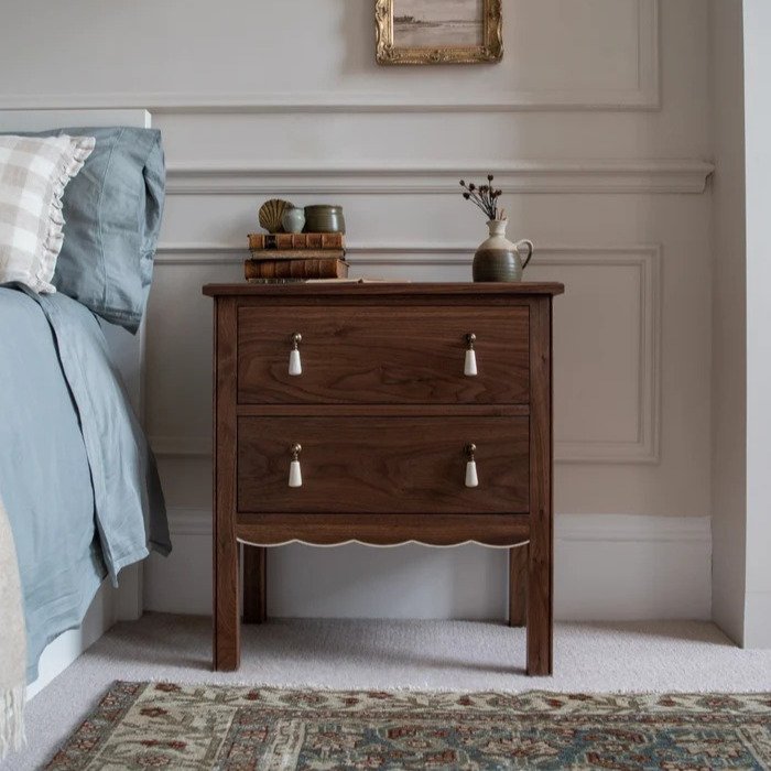 Classic wooden bedside table with two drawers and decorative handles in a rich brown finish